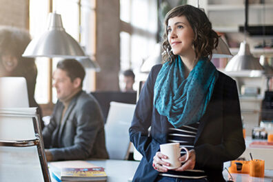 Woman at desk with coffee