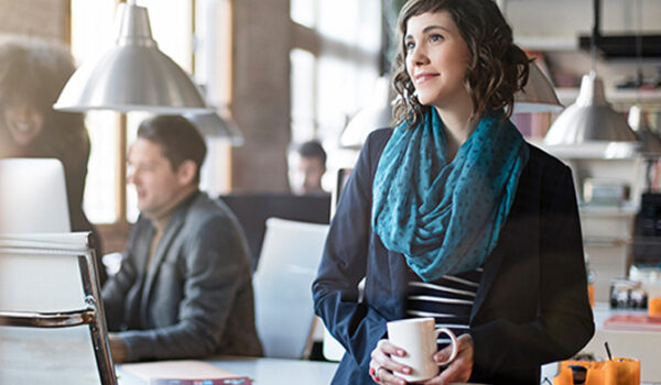 Woman at desk with coffee