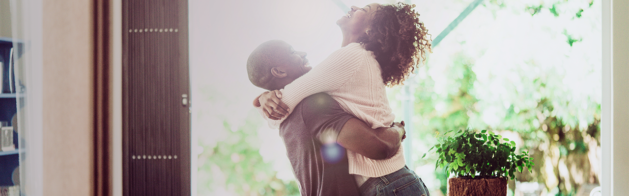 Couple hugging in new home