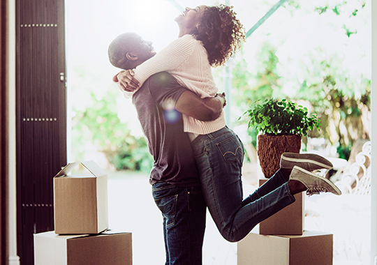 Couple hugging in new home