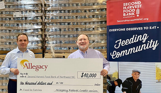 Picture of $10,000 Allegacy oversized check being passed during Second Harvest Food Bank's virtual food drive