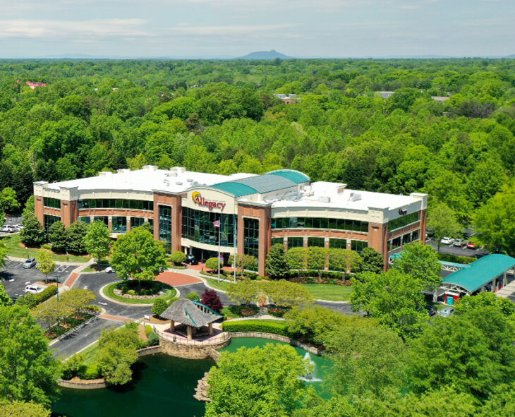 aerial shot of the Allegacy Headquarters including the ponds of hope, the treeline and Pilot Mountain in the background