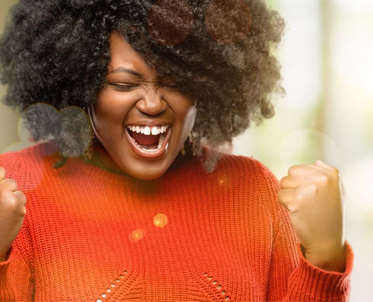 Beautiful african woman happy and excited celebrating victory expressing big success, power, energy and positive emotions