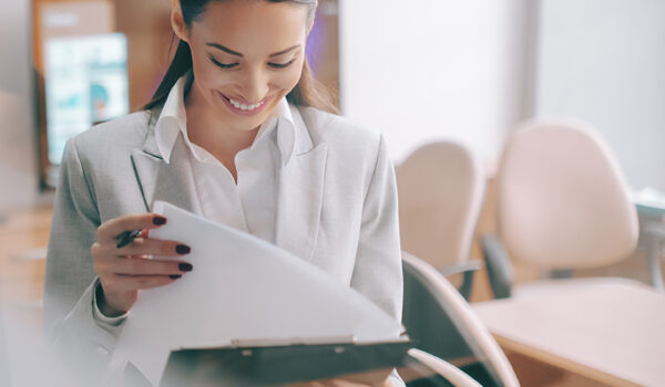 looking through office window to woman