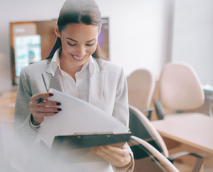 looking through office window to woman