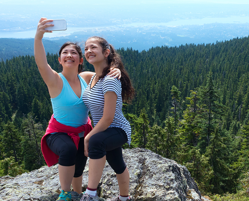 mom with arm around daughter at elevate rocky lookout taking a selfie