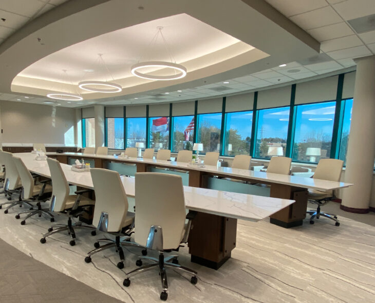 Allegacy's board room brightly lit with flags and blue sky showing through windows