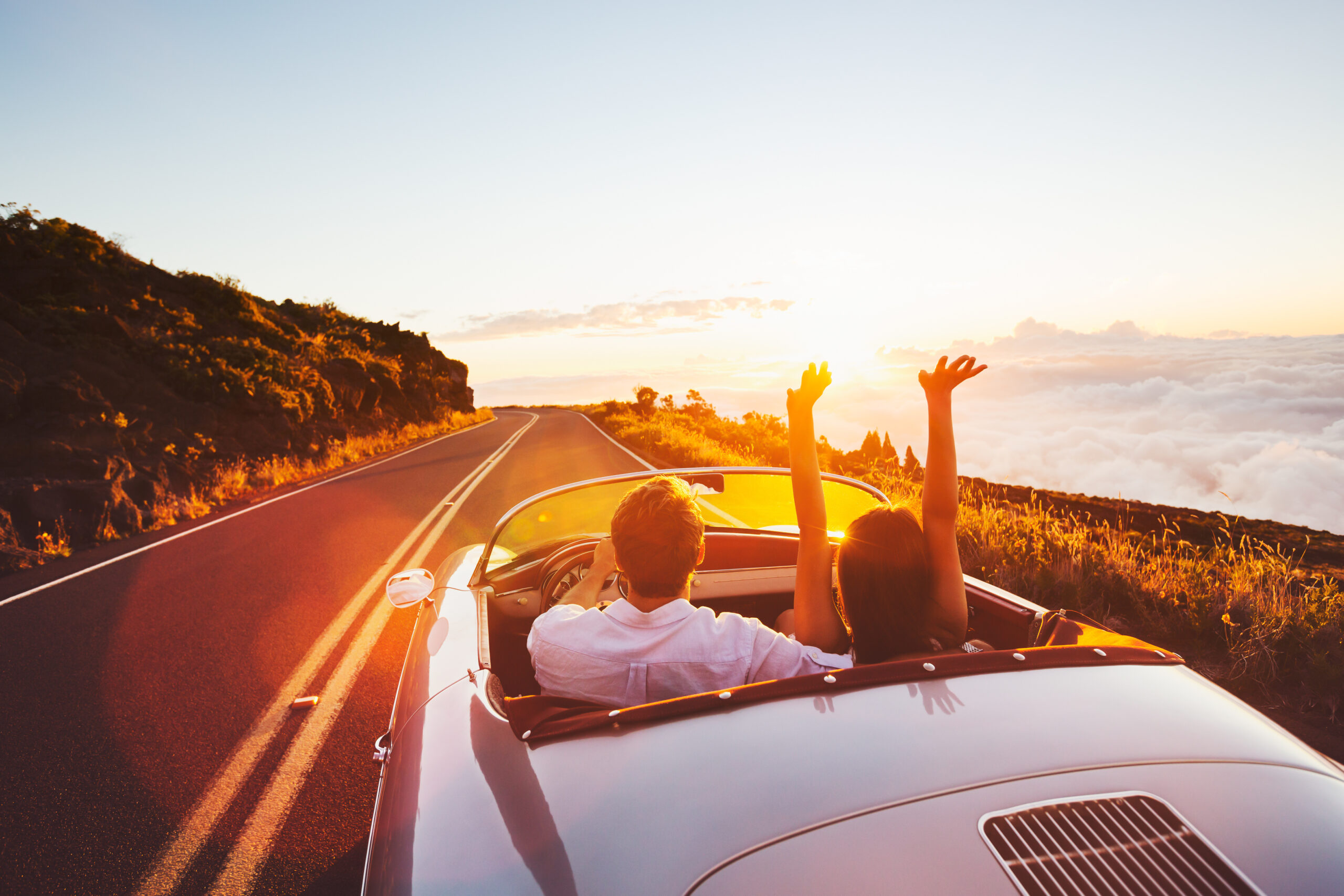 Couple driving into sunset