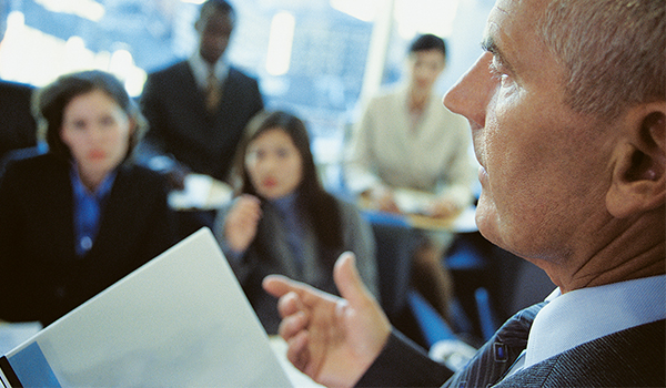 businessman talking to group of colleagues
