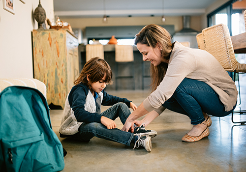 Mother helping son get ready for school