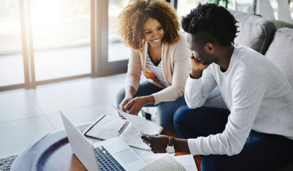 Shot of a young couple going through their paperwork together at home