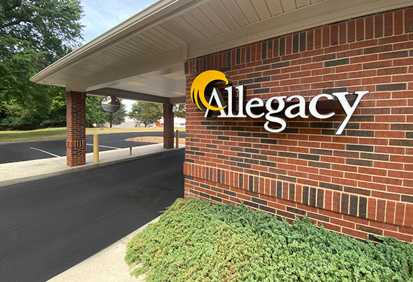 photo of Allegacy logo on brick wall of the Davidson Financial Center near the drive thru lane