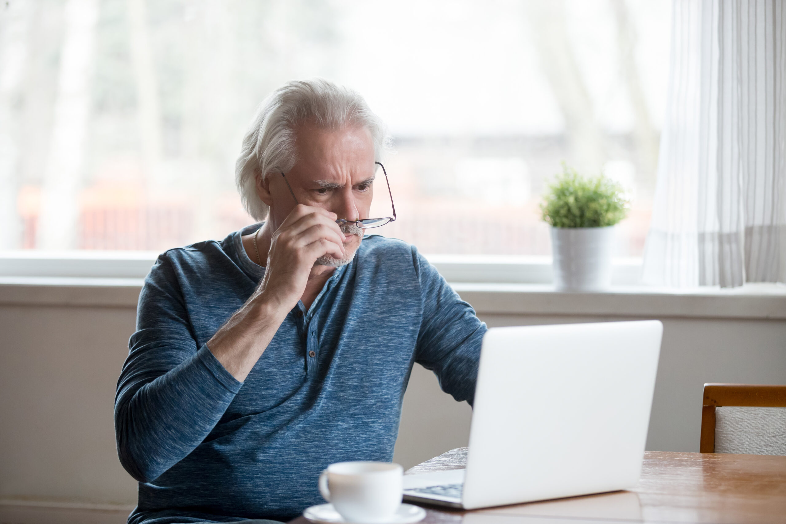 Senior male looking at laptop