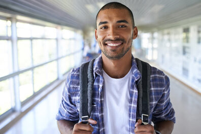 Male Student Smiling in Hallway