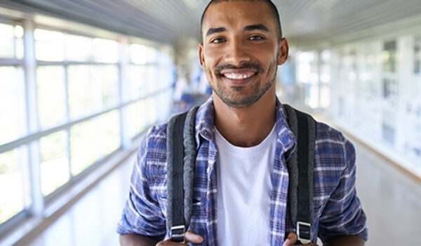 Male Student Smiling in Hallway