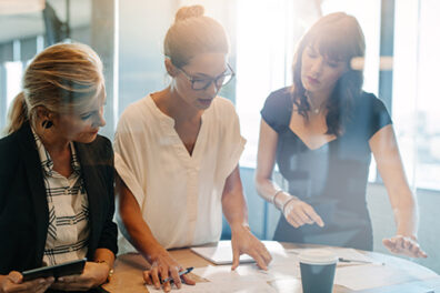 coworkers stand at an office desk