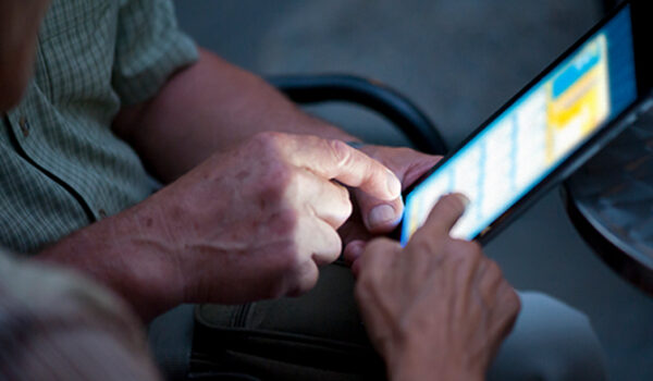 hands exploring tablet