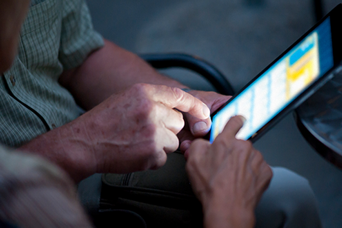 hands exploring tablet