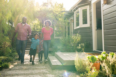 Couple with kids walking outside home