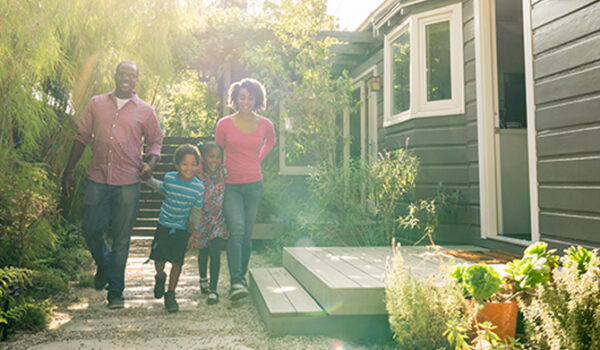 Couple with kids walking outside home