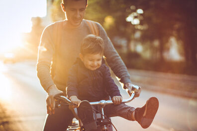 father and son on bicycle