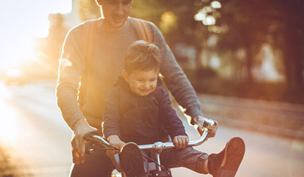 father and son on bicycle