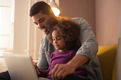 Father and Daughter learn at computer