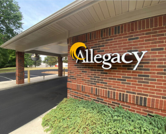 photo of Allegacy logo on brick wall of the Davidson Financial Center near the drive thru lane