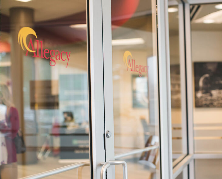 close up of glass doors at an Allegacy Financial Center with the logo featured