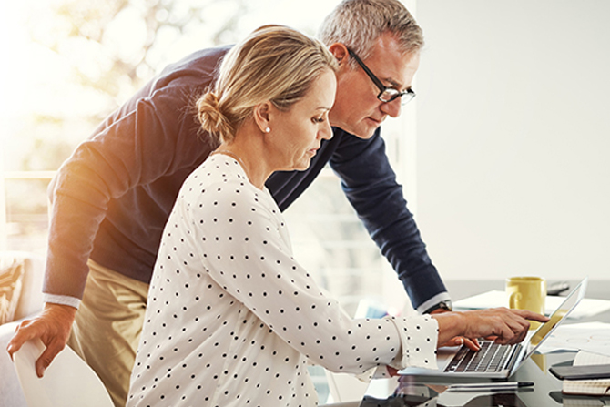 Man and woman looking at laptop screen