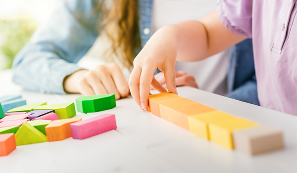 Children's hands playing with blocks