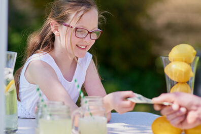 Girl taking money at lemonade stand