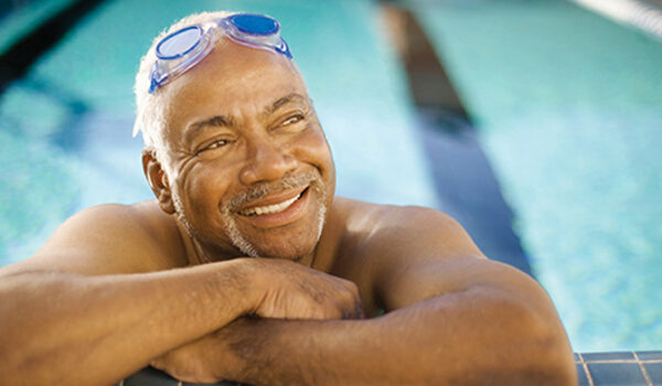 man at side of swimming pool