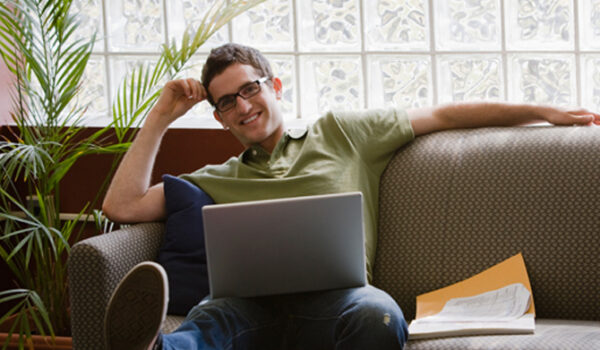 man on sofa with laptop