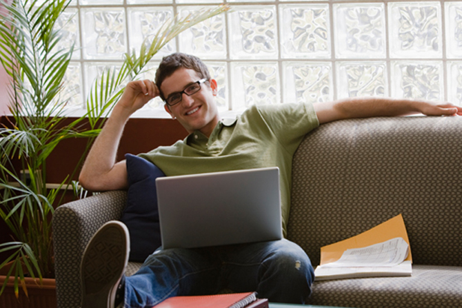 man on sofa with laptop