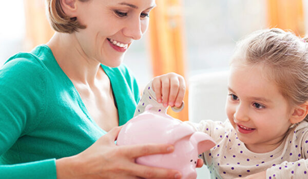 mother and daughter with piggy bank