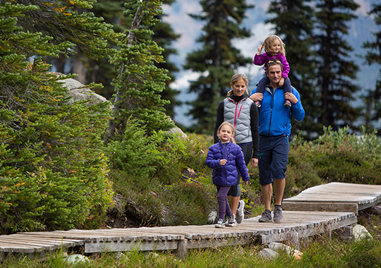 family walking on mountain trail