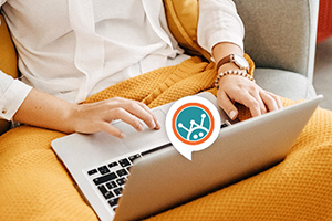 close up of women's hands using laptop with the Welby, digital chat tool logo overlayed