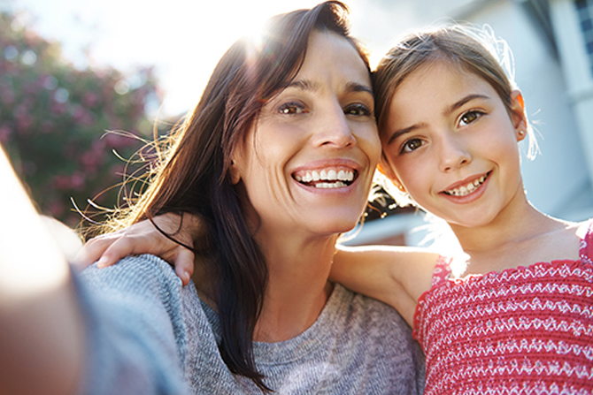 Mom + Daughter selfie in front of new home