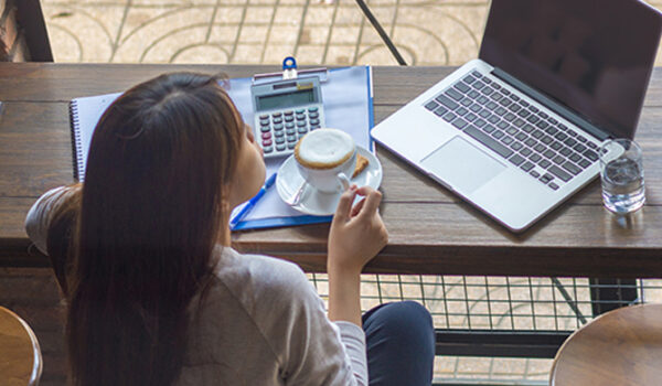 woman with coffee and laptop