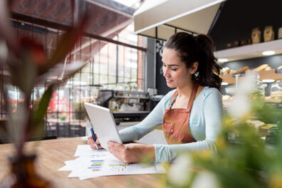 Coffee shop worker on tablet