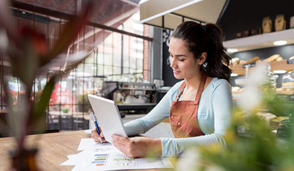 Coffee shop worker on tablet