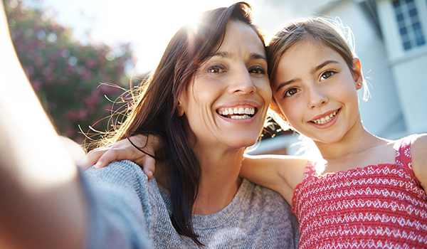 Mom + Daughter selfie in front of new home