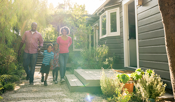 Couple with kids walking outside home